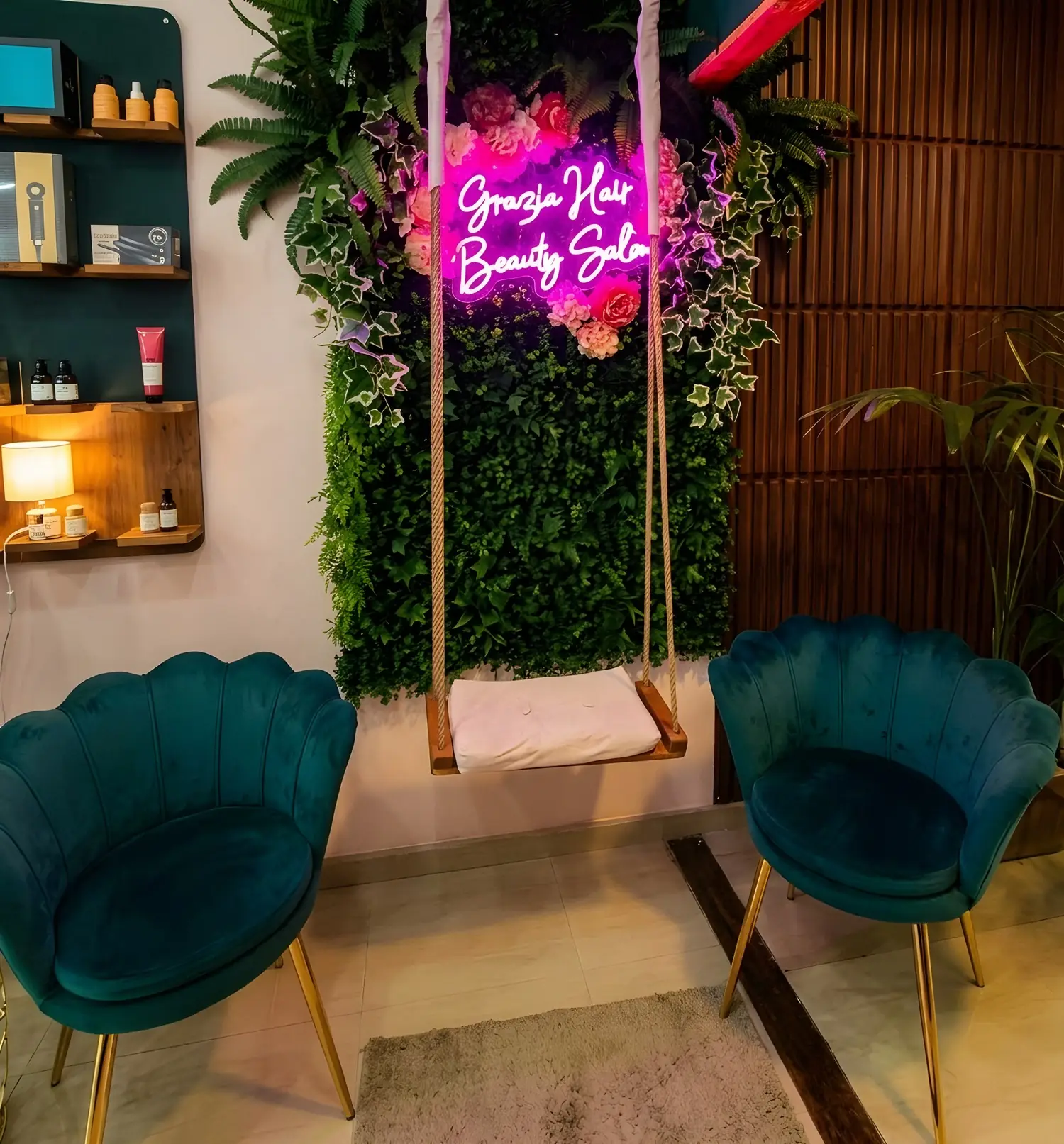 The swing under the Grazia Hair Beauty Salon neon sign, among the plants and green velvet chairs